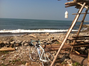 My bike out by a patch of beach along the coast in the morning.
